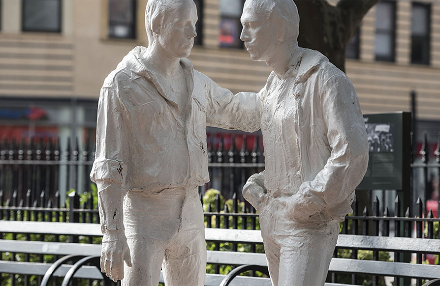 A statue of two people talking to each other in Stonewall National Monument in NYC